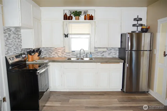 a kitchen with a sink appliances and cabinets