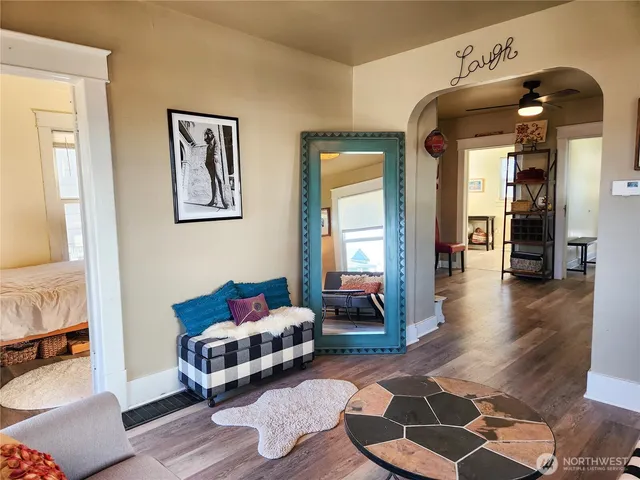 a living room with furniture and wooden floor
