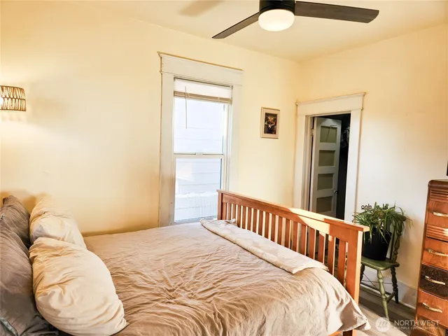 a bedroom with a bed and a window