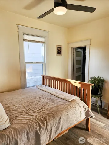 a bedroom with a bed and wooden floor