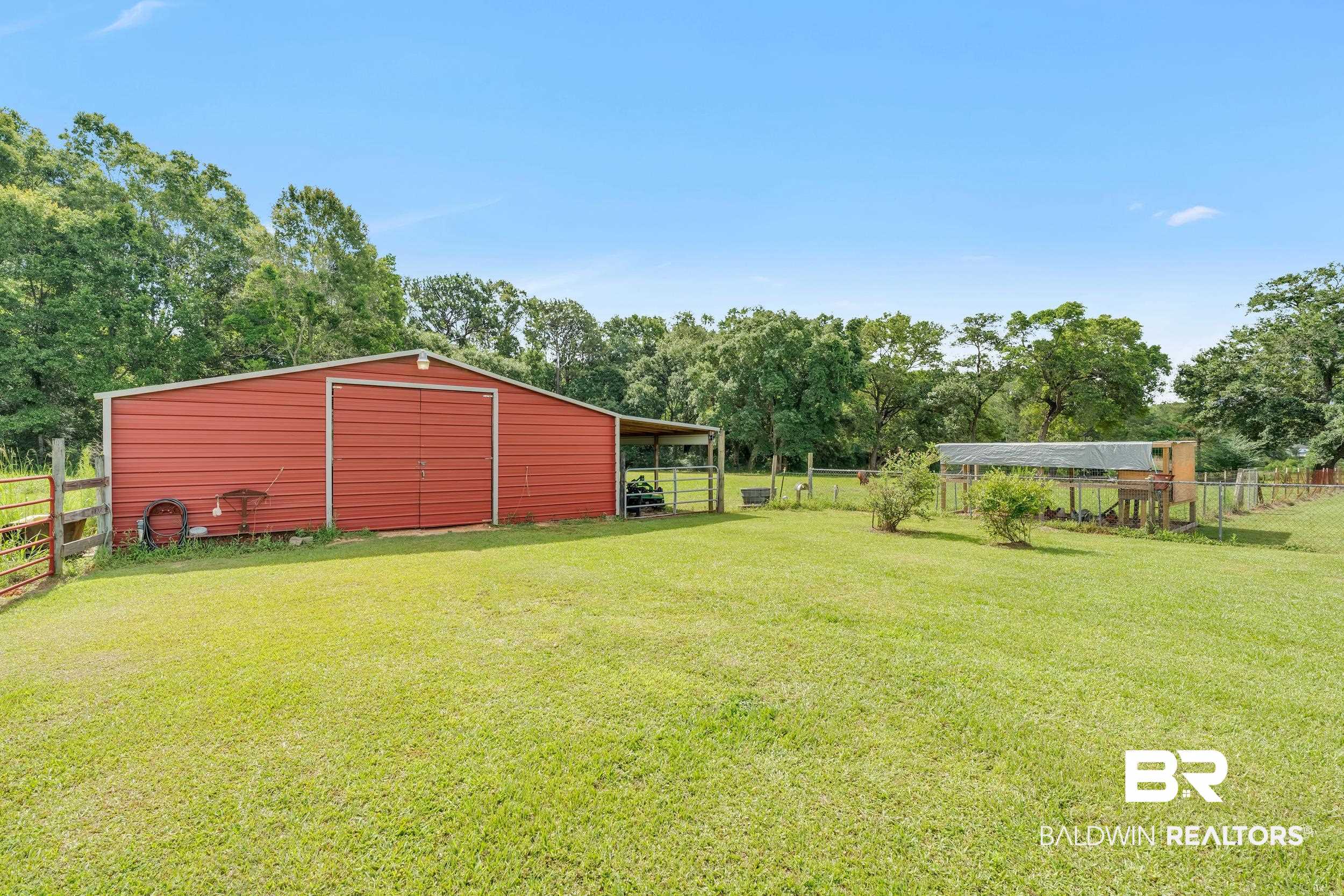 4062 River Road Theodore, AL 36582 - Photo 9 of 32 View of yard with an outbuilding and view of wooded area
