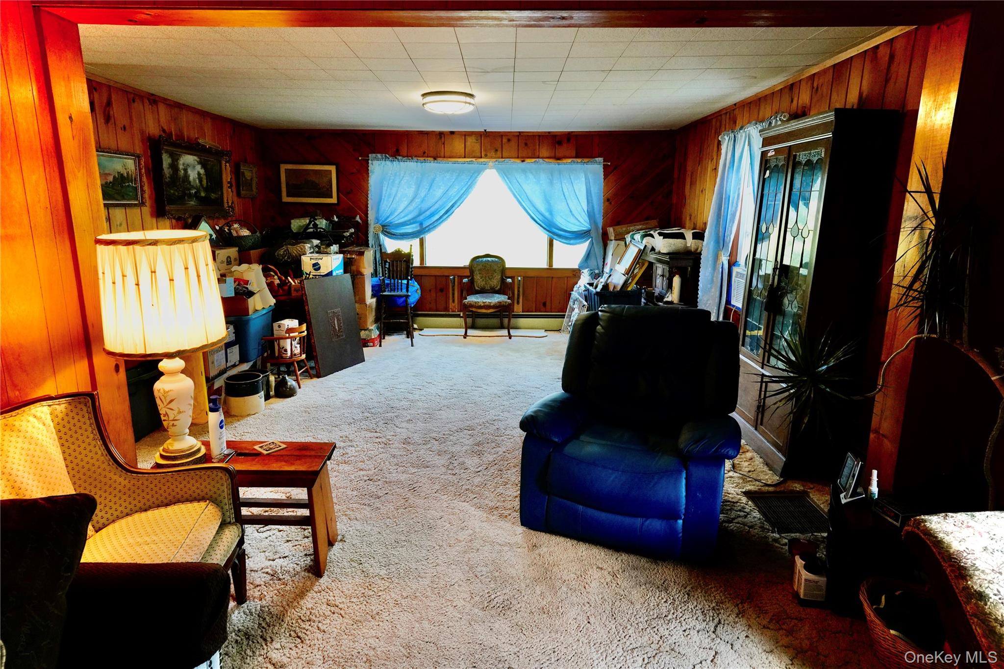 669 Shandelee Road Livingston Manor, NY 12758 - Photo 25 of 46 a living room with furniture a flat screen tv and floor to ceiling window