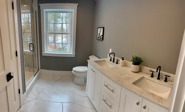 a bathroom with a granite countertop sink mirror vanity and a toilet