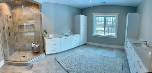 a bathroom with a double vanity sink toilet and shower