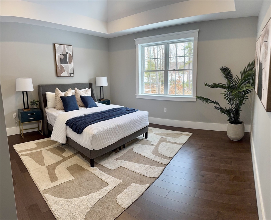 4 Kerri Lane Whitman, MA 02382 - Photo 17 of 24 a bedroom with a large bed and a potted plant