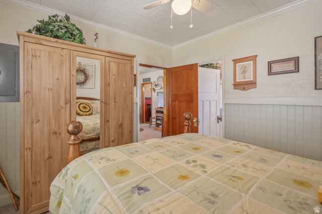 82 South 100 West Lyman, UT 84749 - Photo 23 of 27 Bedroom with a closet, electric panel, wainscoting, crown molding, and a ceiling fan