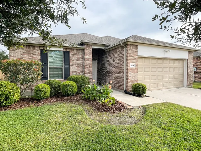 a view of a house with a small yard and plants