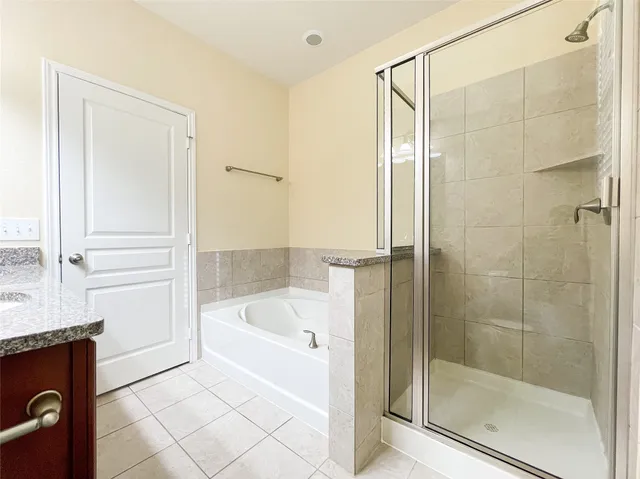 a white bath tub sitting next to a shower