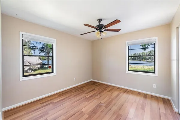 a view of empty room with wooden floor