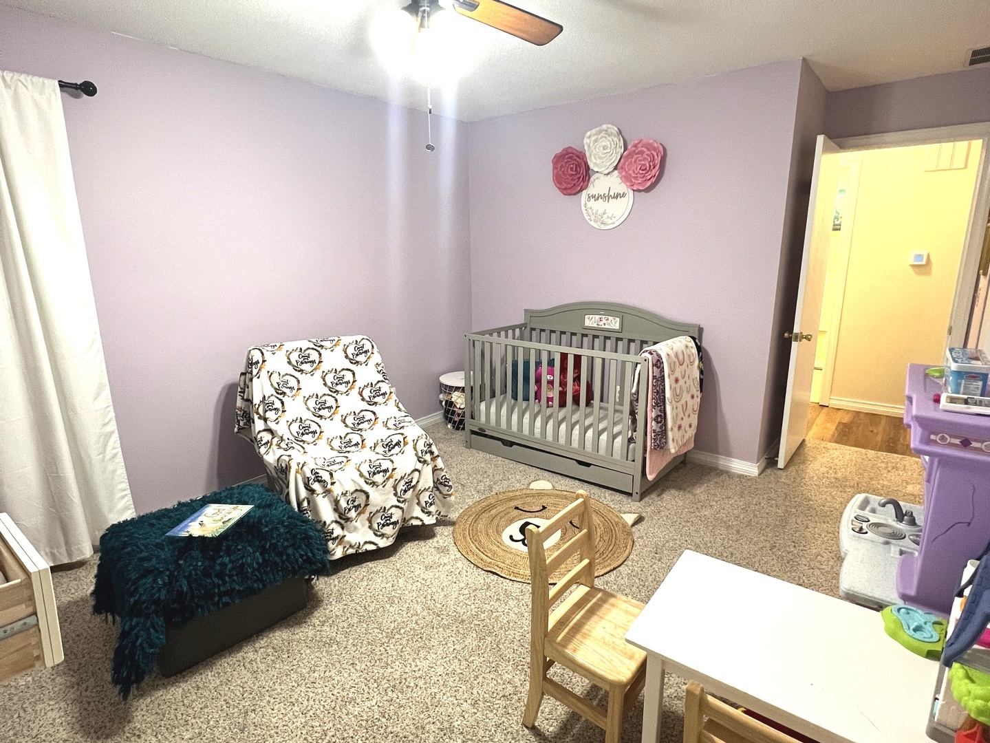 106 Spring Circle, Unit 106 Urbana, IL 61802 - Photo 14 of 18 a living room with furniture and a baby crib