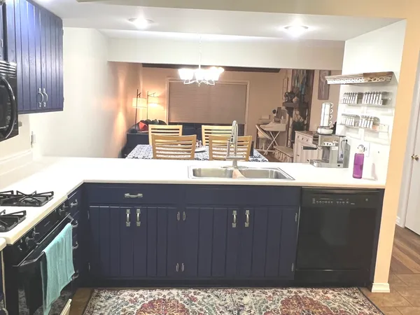 a kitchen with a sink a stove and cabinets