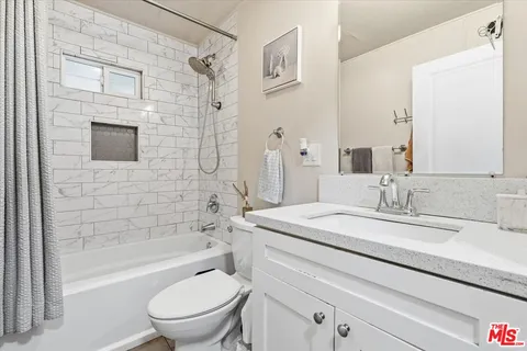 a bedroom with a bed and cabinets