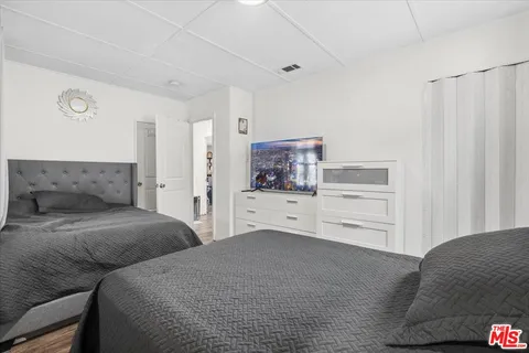a bathroom with a granite countertop sink a toilet and shower