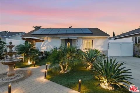 a view of a house with a small yard and plants