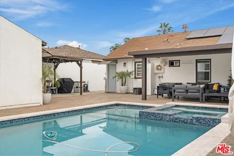 a outdoor living space with furniture and a flat screen tv