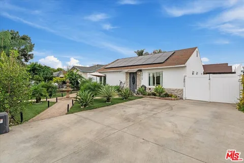 a view of a chairs and table under an umbrella