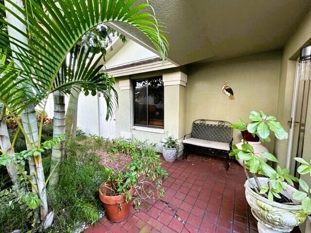 150 Cape Pointe Circle Jupiter, FL 33477 - Photo 21 of 22 a front view of a house with a garden