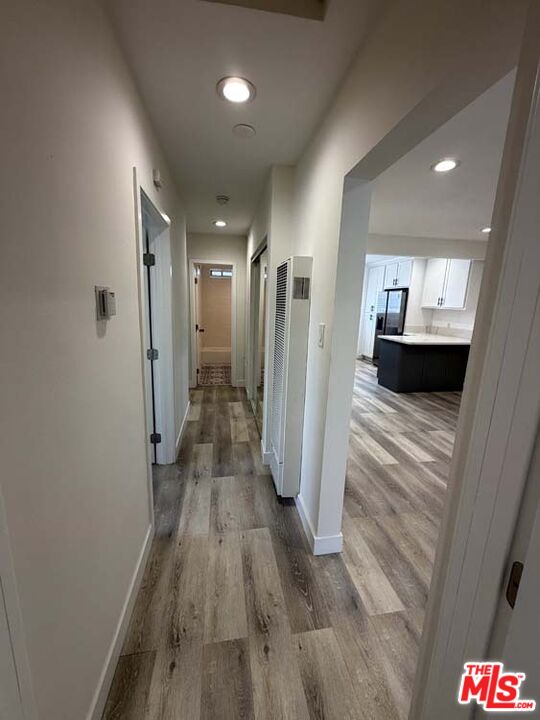 8818 Ramsgate Avenue, Unit 8822 1/2 Los Angeles, CA 90045 - Photo 11 of 20 a view of a hallway with wooden floor and a living room