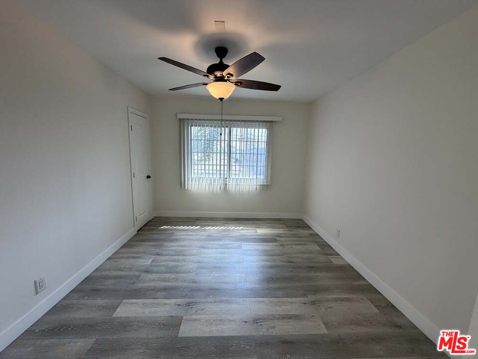 8818 Ramsgate Avenue, Unit 8822 1/2 Los Angeles, CA 90045 - Photo 12 of 20 a view of an empty room with wooden floor and a window