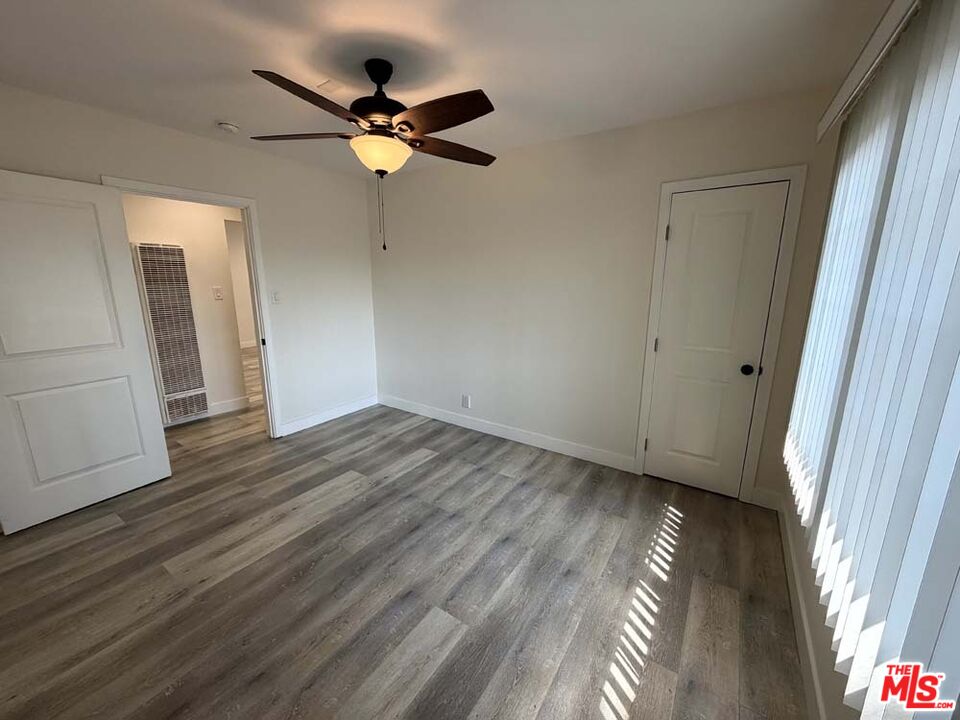8818 Ramsgate Avenue, Unit 8822 1/2 Los Angeles, CA 90045 - Photo 13 of 20 a view of a livingroom with wooden floor and a ceiling fan