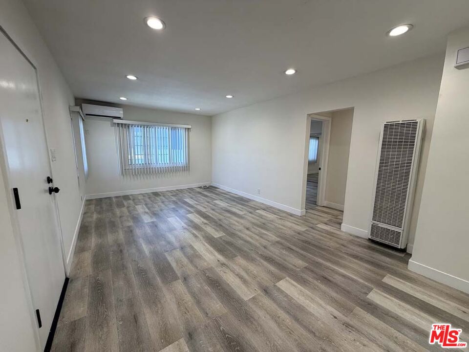 8818 Ramsgate Avenue, Unit 8822 1/2 Los Angeles, CA 90045 - Photo 2 of 20 an empty room with wooden floor and a window