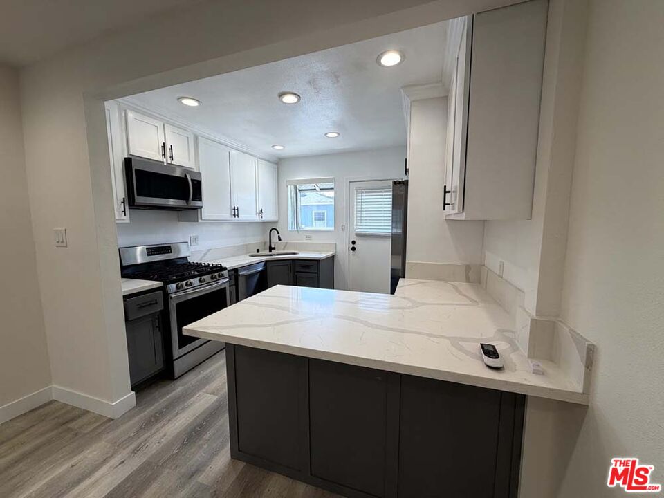 8818 Ramsgate Avenue, Unit 8822 1/2 Los Angeles, CA 90045 - Photo 5 of 20 a kitchen with a sink a stove and refrigerator