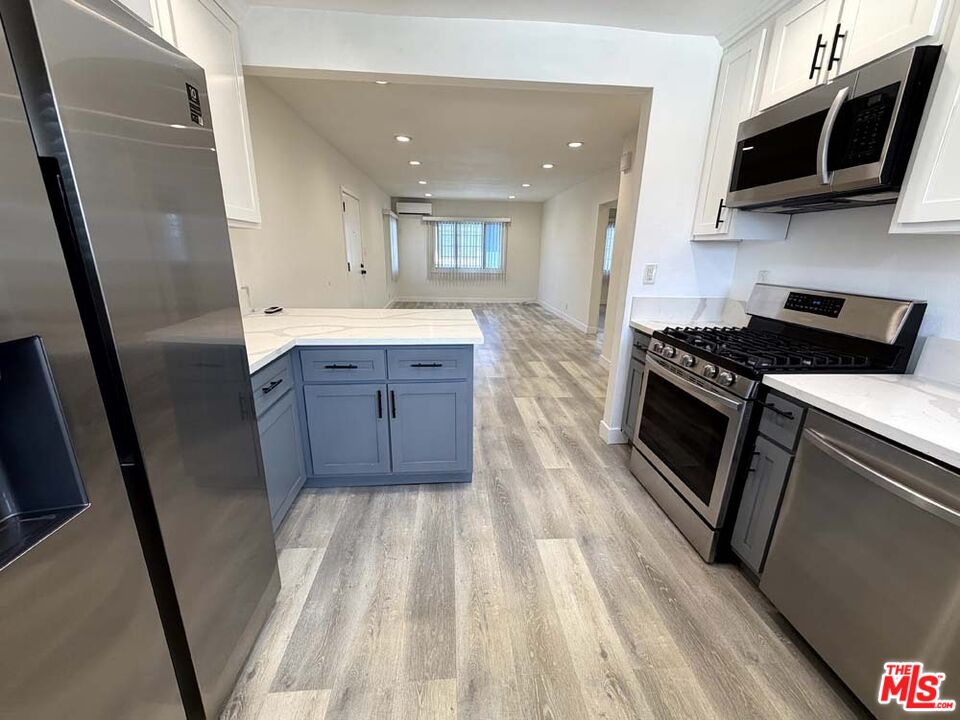 8818 Ramsgate Avenue, Unit 8822 1/2 Los Angeles, CA 90045 - Photo 7 of 20 a kitchen with stainless steel appliances granite countertop a stove a sink and a refrigerator