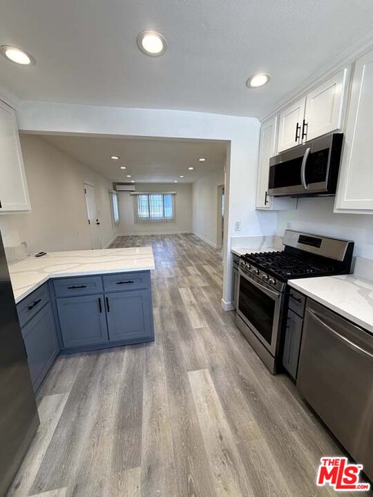 8818 Ramsgate Avenue, Unit 8822 1/2 Los Angeles, CA 90045 - Photo 8 of 20 a kitchen with stainless steel appliances granite countertop a stove a sink and a microwave