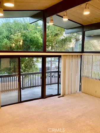 a view of a porch with a floor to ceiling window