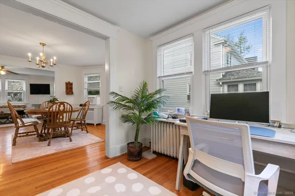 a workspace with furniture a potted plant and a fireplace