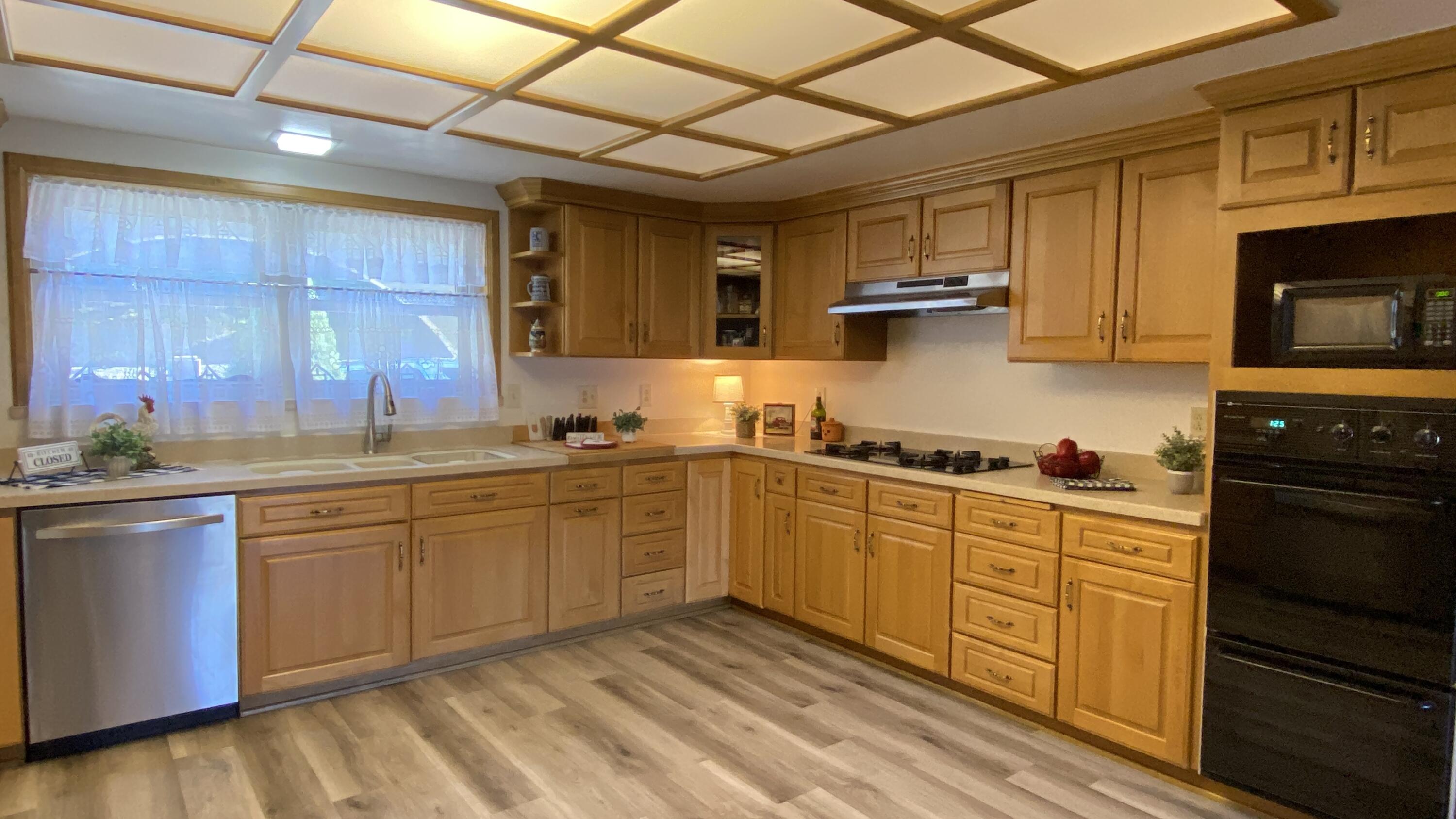 1401 San Miguelito Road Lompoc, CA 93436 - Photo 18 of 61 a kitchen with stainless steel appliances granite countertop a stove sink and cabinets