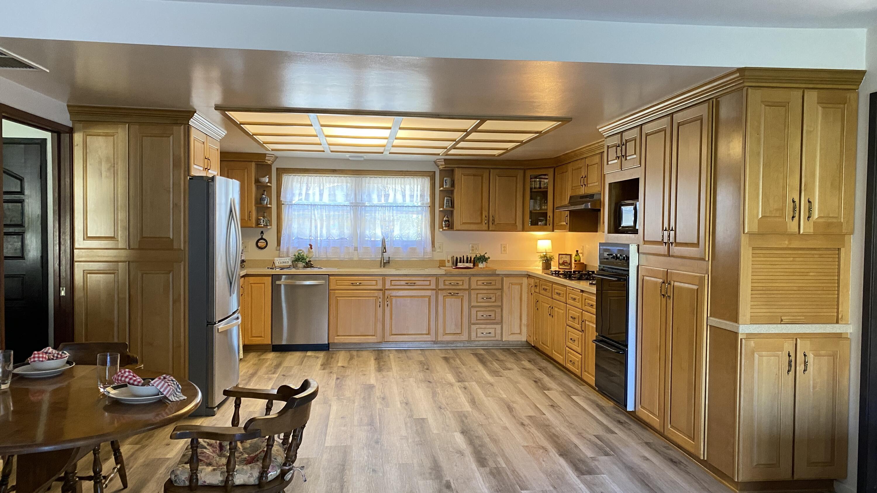 1401 San Miguelito Road Lompoc, CA 93436 - Photo 20 of 61 a kitchen with stainless steel appliances a refrigerator and wooden cabinets