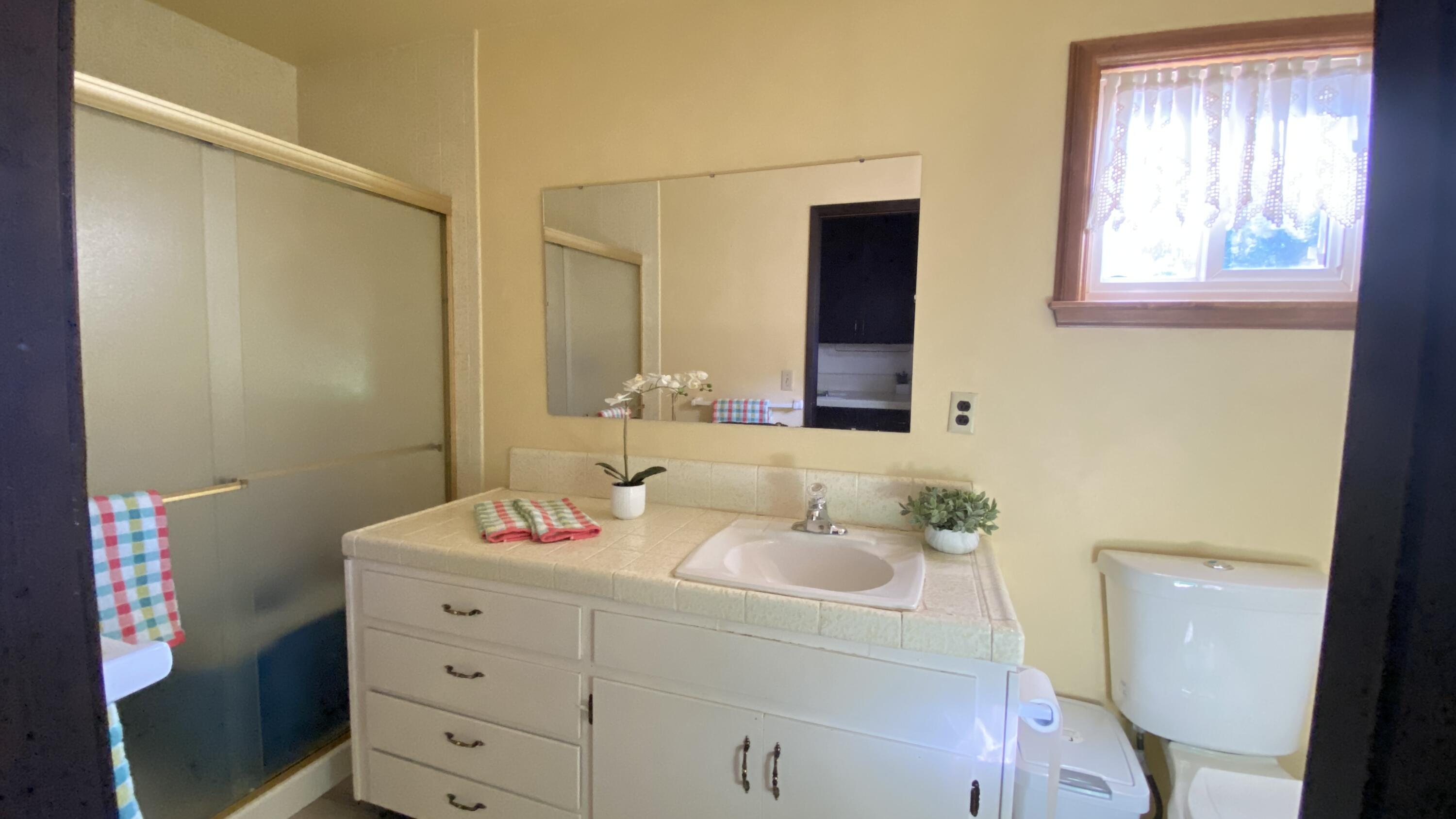 1401 San Miguelito Road Lompoc, CA 93436 - Photo 31 of 61 a bathroom with a sink mirror vanity and toilet