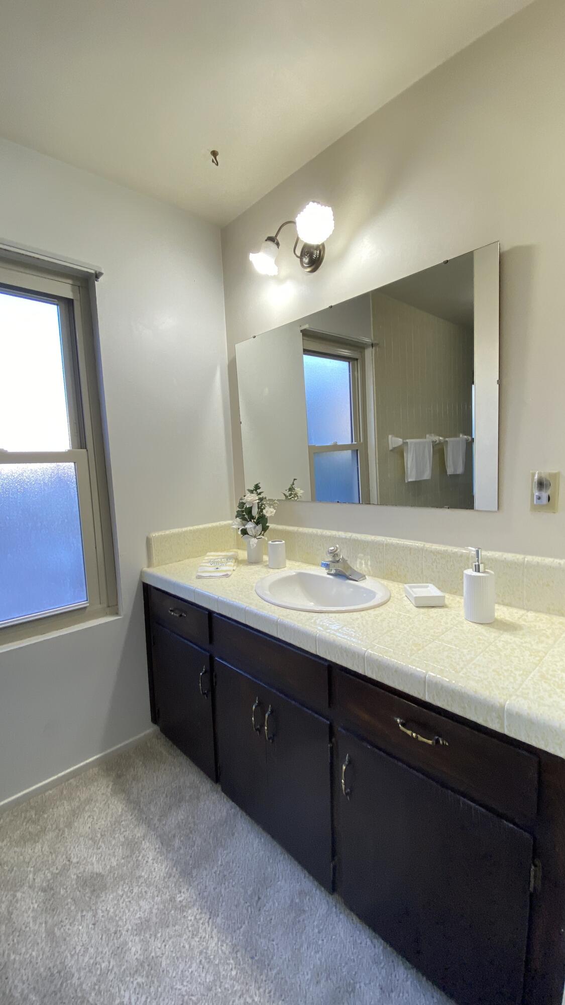 1401 San Miguelito Road Lompoc, CA 93436 - Photo 40 of 61 a bathroom with a sink vanity and mirror