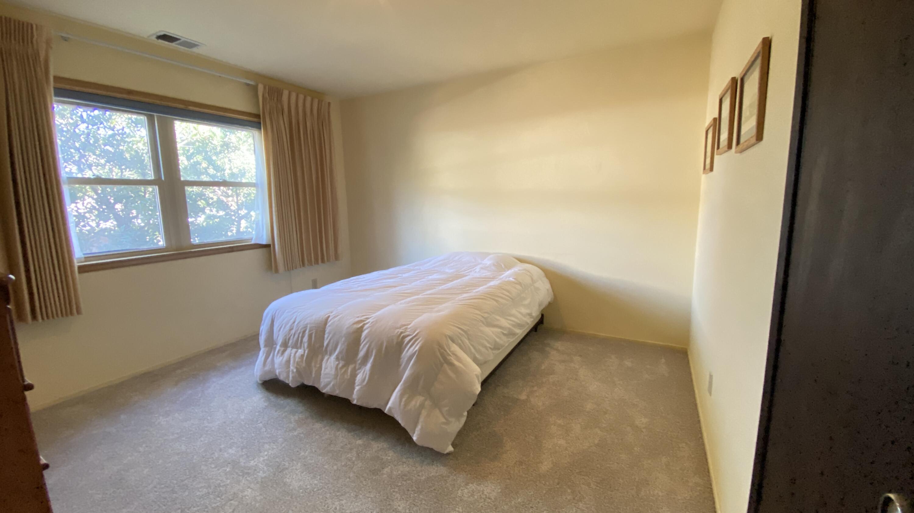 1401 San Miguelito Road Lompoc, CA 93436 - Photo 44 of 61 a bed sitting in a bedroom next to a window