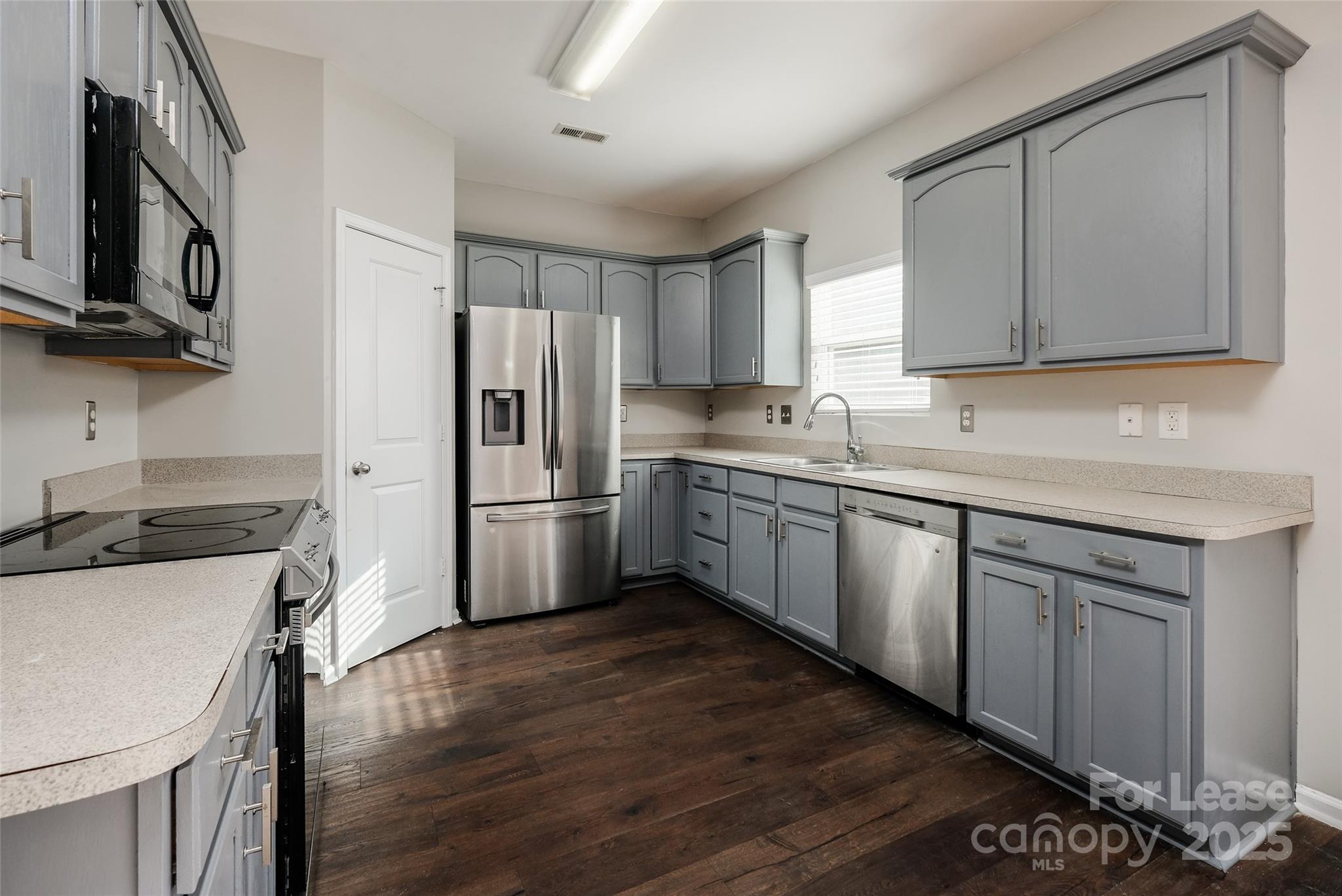 13027 Rothe House Road Charlotte, NC 28273 - Photo 11 of 31 a kitchen with a sink cabinets stainless steel appliances and a window