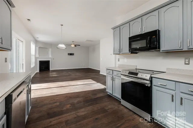 a kitchen with granite countertop a stove and a sink