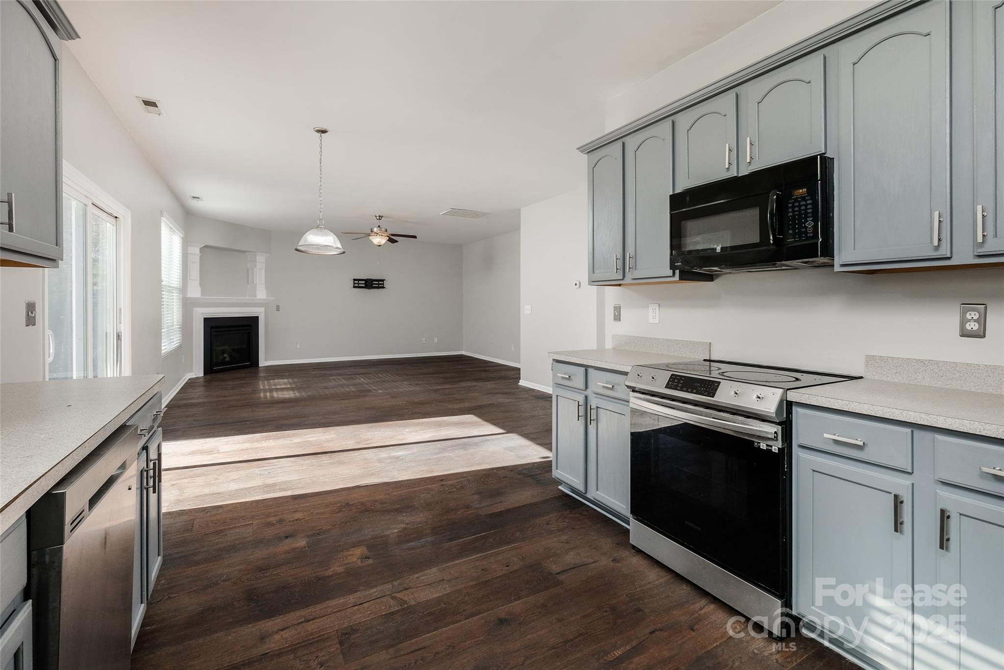 13027 Rothe House Road Charlotte, NC 28273 - Photo 12 of 31 a kitchen with granite countertop a stove and a sink