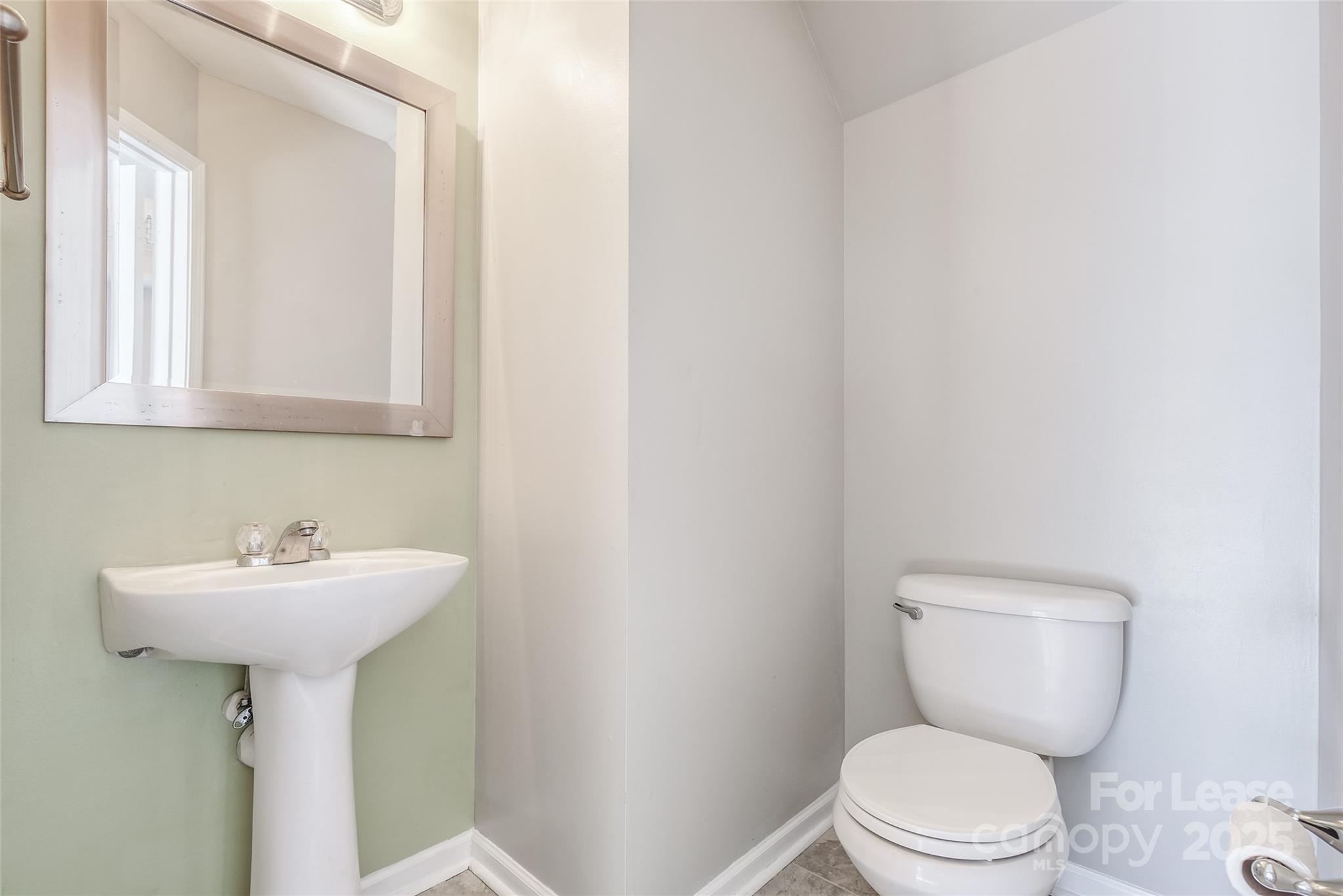 13027 Rothe House Road Charlotte, NC 28273 - Photo 13 of 31 a bathroom with a toilet sink and mirror