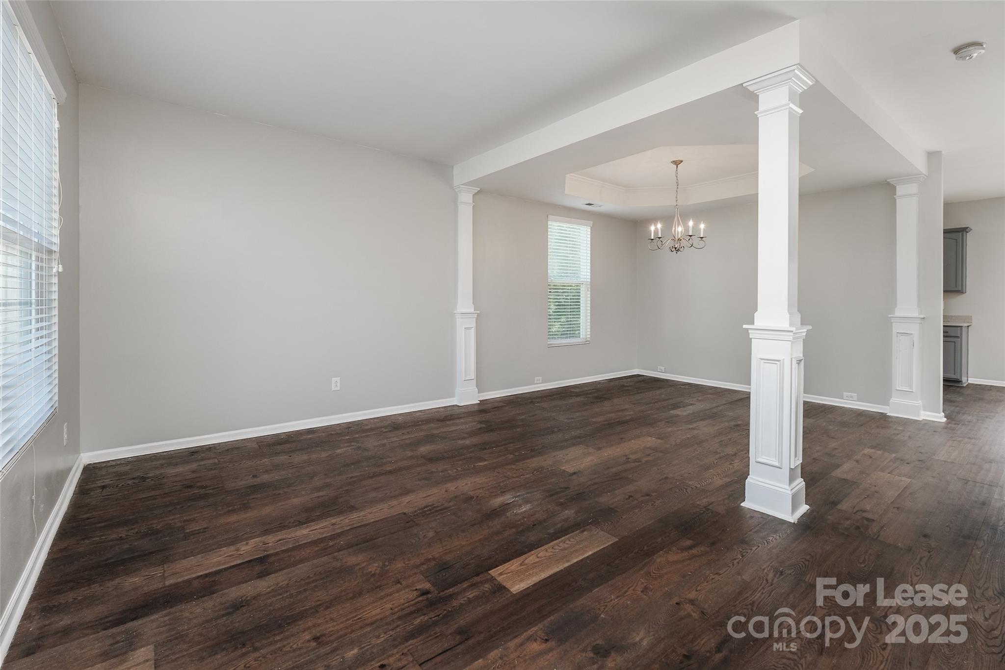 13027 Rothe House Road Charlotte, NC 28273 - Photo 2 of 31 an empty room with wooden floor and windows