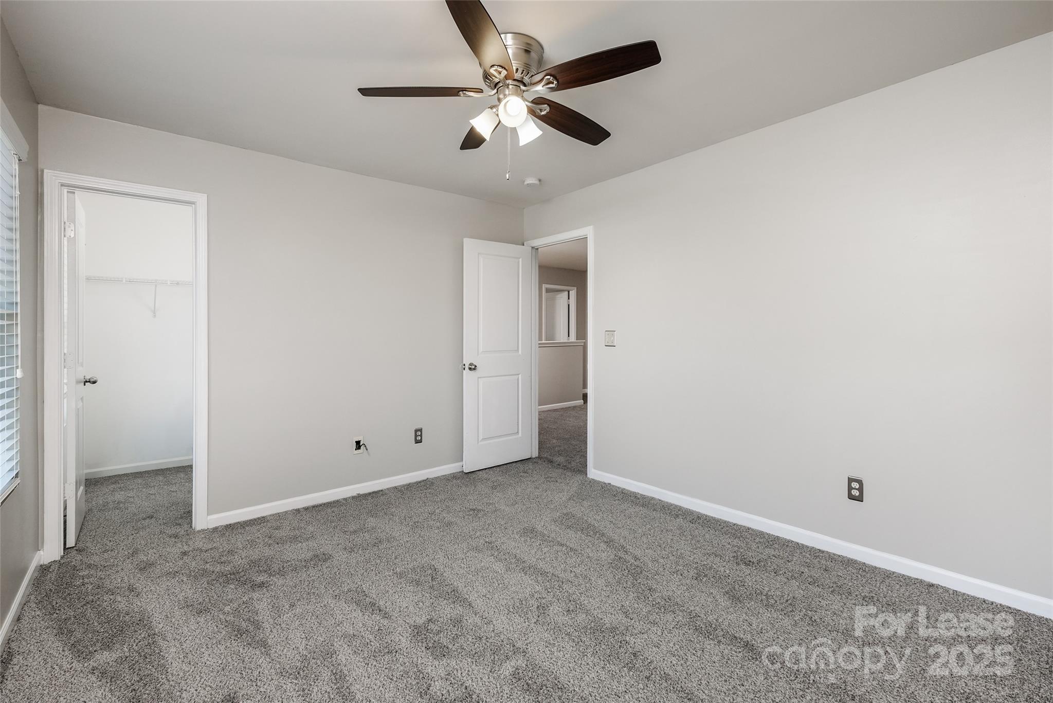 13027 Rothe House Road Charlotte, NC 28273 - Photo 28 of 31 an empty room with chandelier fan