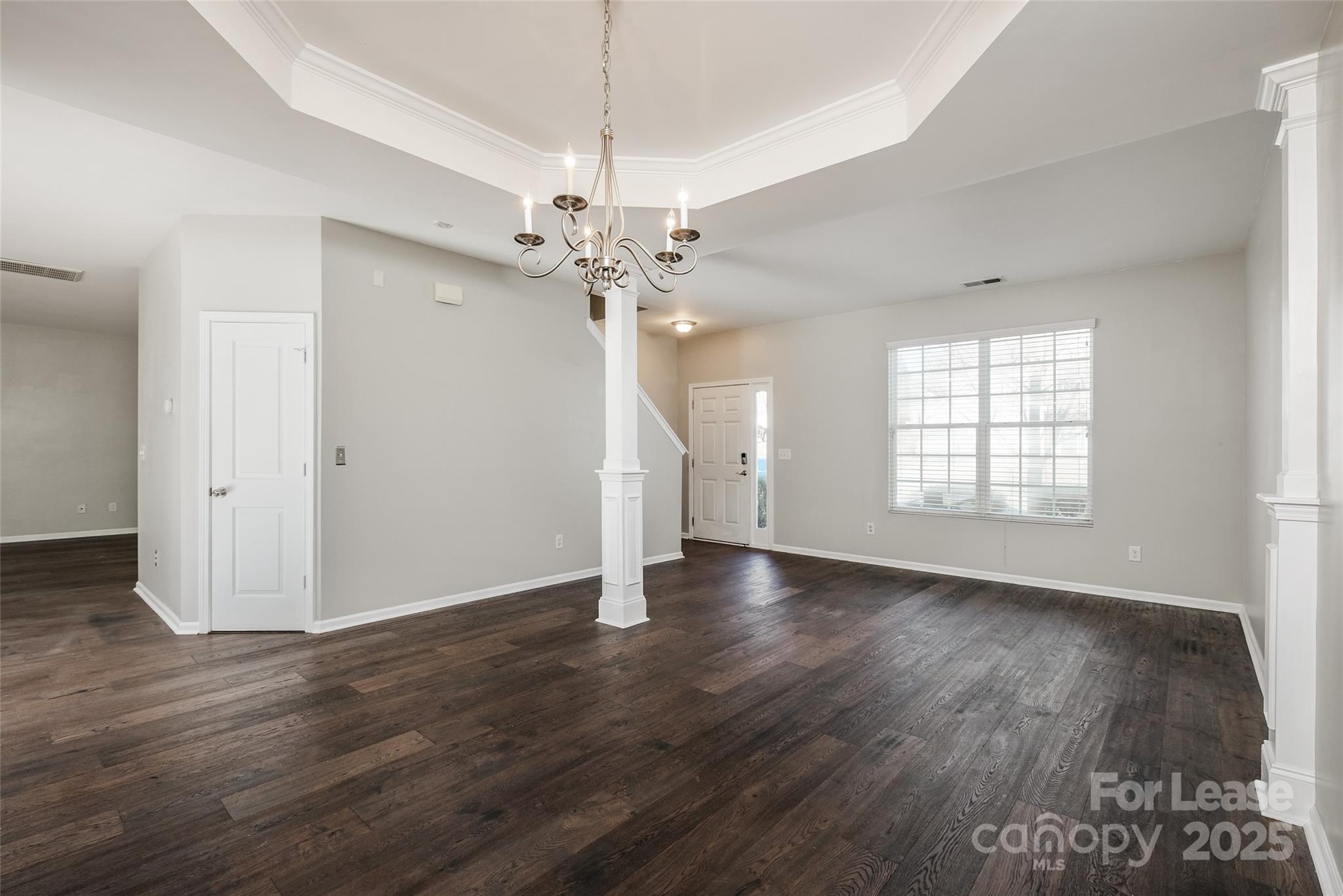 13027 Rothe House Road Charlotte, NC 28273 - Photo 4 of 31 an empty room with wooden floor and windows