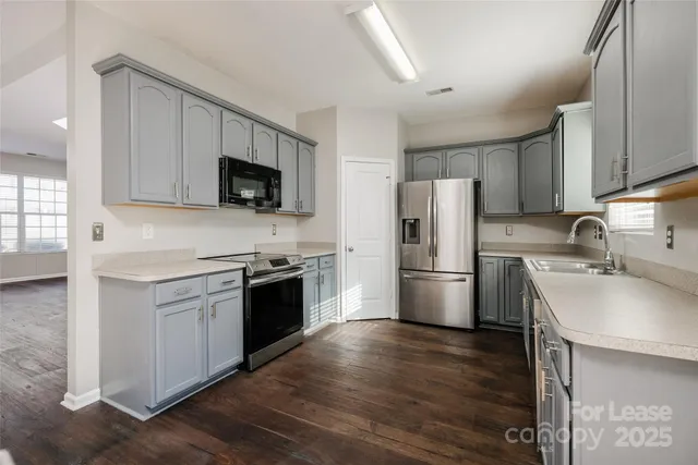 a kitchen with a stove a sink and a refrigerator