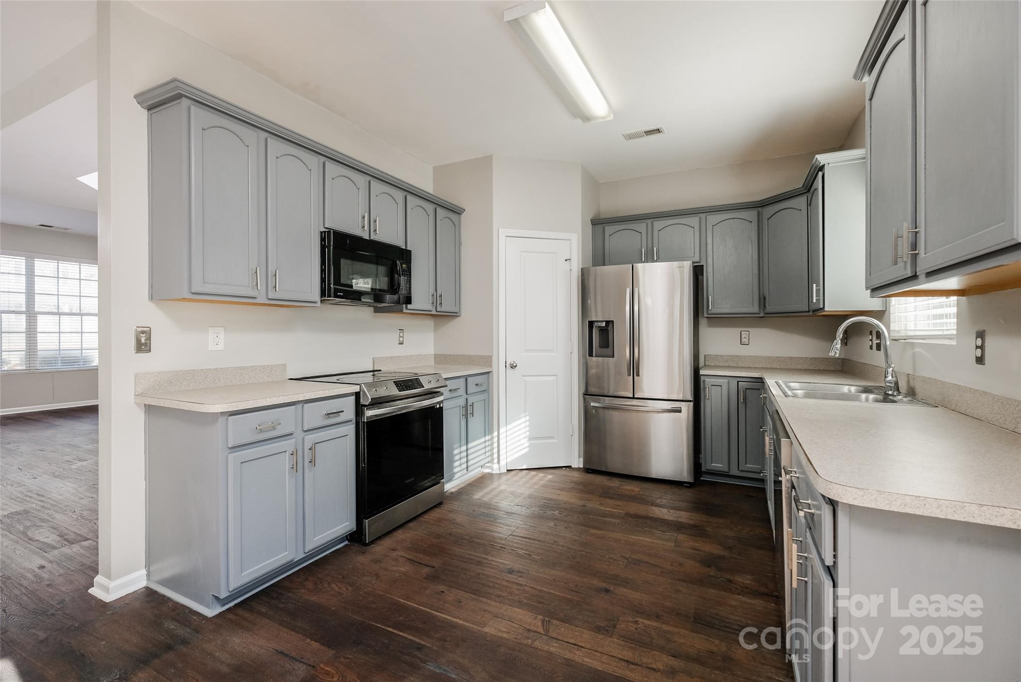 13027 Rothe House Road Charlotte, NC 28273 - Photo 10 of 31 a kitchen with a stove a sink and a refrigerator