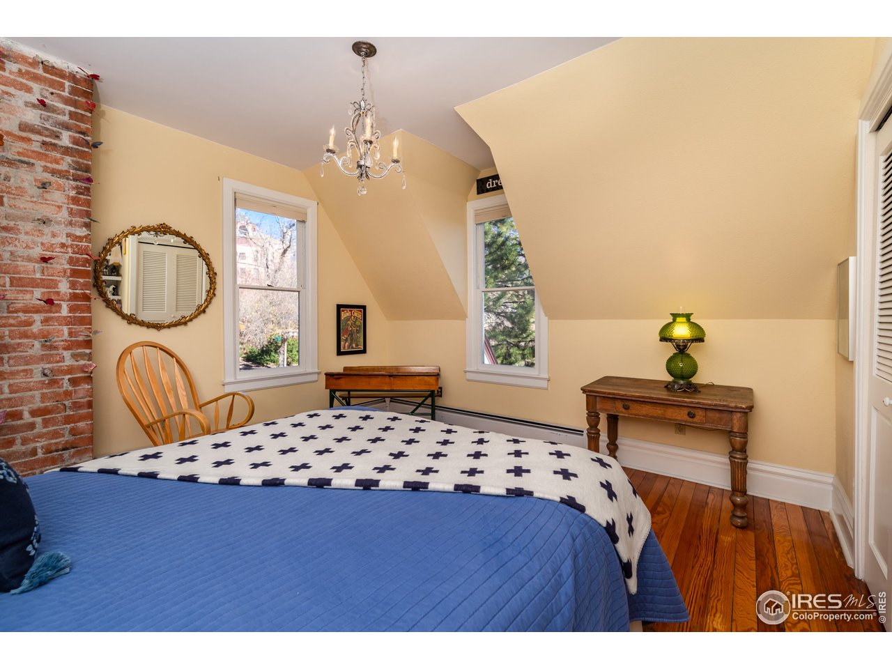 809 Pine Street Boulder, CO 80302 - Photo 19 of 38 a bedroom with a bed dresser and a window