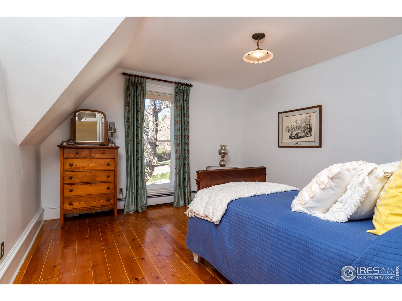 809 Pine Street Boulder, CO 80302 - Photo 20 of 38 a bedroom with a bed and a dresser