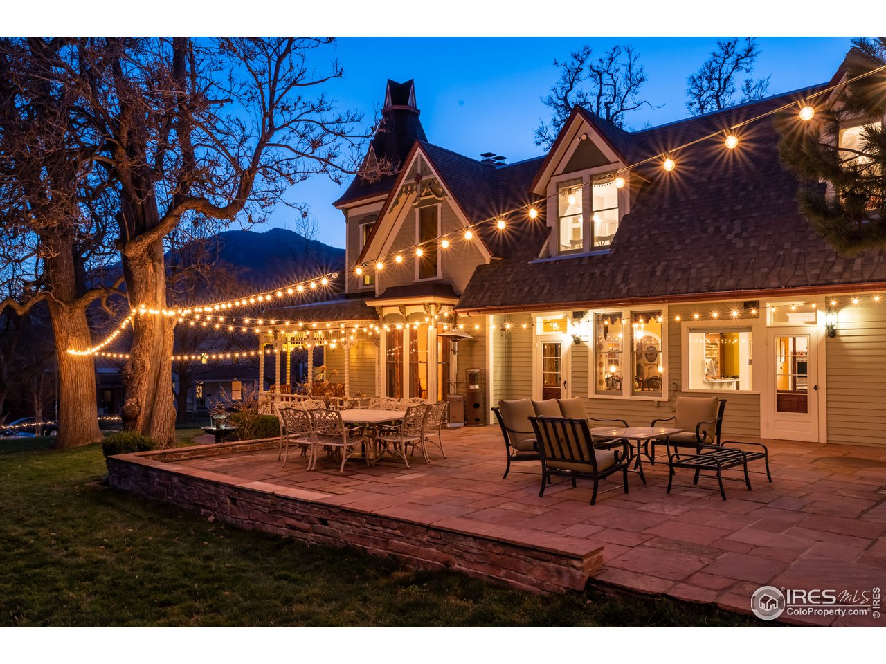 809 Pine Street Boulder, CO 80302 - Photo 30 of 38 a view of a patio with dining table and chairs with a barbeque grill and a fireplace