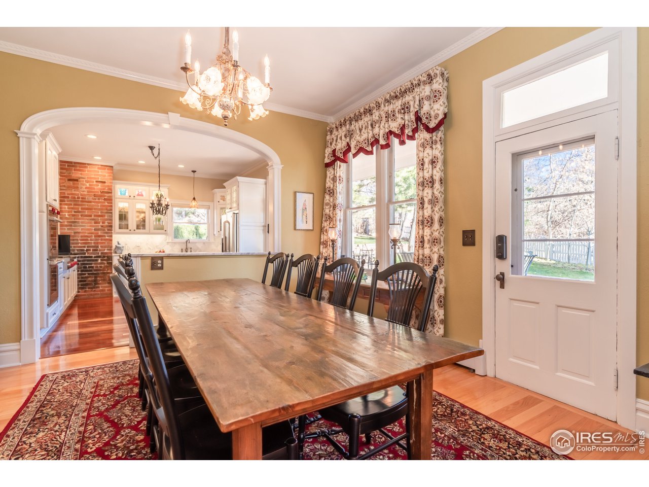 809 Pine Street Boulder, CO 80302 - Photo 7 of 38 a dining room with a table chairs and kitchen view