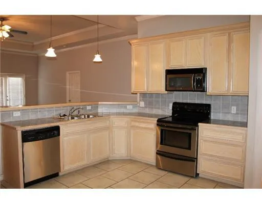 a kitchen with stainless steel appliances a stove sink and microwave