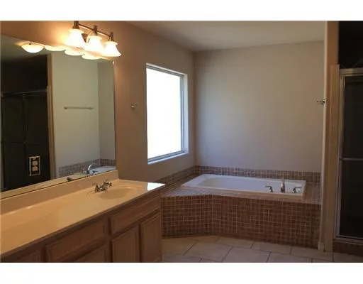 a bathroom with a sink vanity granite and a mirror